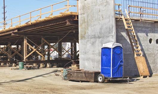 the convenience of on-site restrooms a construction site lined with portable restrooms